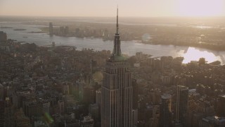 AX93_033 - 4K aerial stock footage Flying by the Empire State Building, Midtown Manhattan, New York, sunset