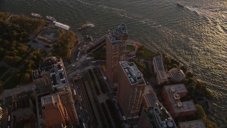 AX93_073 - 4K aerial stock footage Orbiting skyscrapers, West Street, Lower Manhattan, New York, New York, sunset