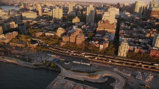 AX93_079 - 4K aerial stock footage Panning left by traffic, Brooklyn Queens Freeway, Brooklyn, New York, New York, sunset