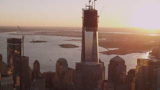 AX93_091 - 4K aerial stock footage Flying by One World Trade Center, Lower Manhattan, New York, New York, sunset