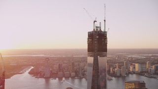 AX93_095 - 4K aerial stock footage of One World Trade Center, reveal World Trade Center Memorial, New York, sunset
