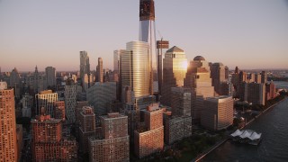 AX93_101 - 4K aerial stock footage Flying by World Trade Center, Lower Manhattan, skyscrapers, New York, sunset