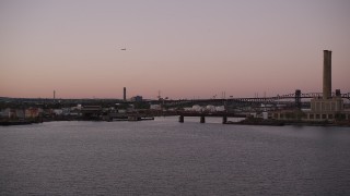 AX93_130 - 4K aerial stock footage Approaching an oil refinery, factory, Passaic River, Newark, New Jersey, twilight