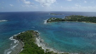 AX96_157 - 5k stock footage aerial stock footage approach and orbit Little St James Island in sapphire blue waters, St Thomas, Virgin Islands