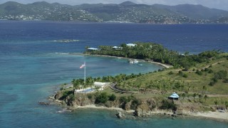 AX96_161 - 5k stock footage aerial stock footage orbit American flag and pool area on Little St James Island, St Thomas, Virgin Islands