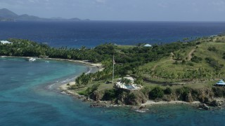 AX96_162 - 5k stock footage aerial stock footage orbiting American flag and pool area on Little St James Island, St Thomas, Virgin Islands