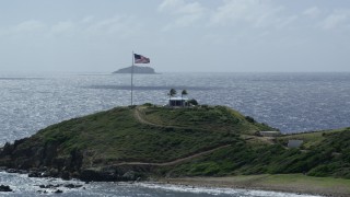 AX96_165 - 5k stock footage aerial stock footage American flag and circular building on Little St James Island, St Thomas, Virgin Islands