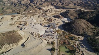 AXSF01_001 - 5K aerial stock footage of orbiting a quarry with industrial equipment, Simi Valley, California
