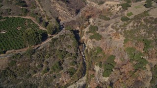 AXSF01_009 - 5K aerial stock footage of approaching Ojai Road beside Santa Paula Creek, Santa Paula, California