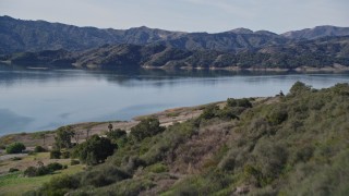 AXSF01_016 - 5K aerial stock footage of flying over a wooded hillside, revealing Lake Casitas, California