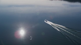 AXSF01_022 - 5K aerial stock footage of tracking a fishing boat cruising on the lake, Lake Casitas, California