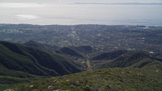 AXSF01_028 - 5K aerial stock footage of flying over a mountain, revealing Santa Barbara, Santa Ynez Mountains, California