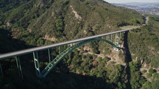 AXSF01_036 - 5K aerial stock footage tilt from trees to reveal Cold Springs Canyon Arch Bridge, Santa Ynez Mountains, California