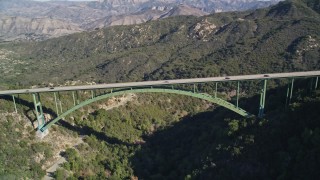 AXSF01_037 - 5K aerial stock footage of flying by the Cold Springs Canyon Arch Bridge, Santa Ynez Mountains, California