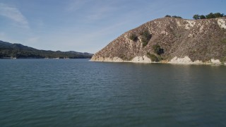 AXSF01_043 - 5K aerial stock footage fly low over Lake Cachuma, and over a hill on the shore, Santa Barbara County, California