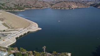 AXSF01_045 - 5K aerial stock footage of flying by Lake Cachuma, revealing Bradbury Dam; Lake Cachuma, California