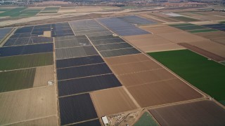 AXSF02_007 - 5K aerial stock footage of flying by fields of crops, rural landscape, Santa Maria, California