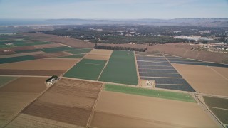 AXSF02_011 - 5K aerial stock footage tilt up and fly over geometric farmland, Nipomo, California