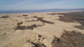 AXSF02_020 - 5K aerial stock footage fly over and pan across sand dunes, Pismo Dunes, California