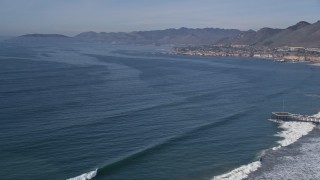 AXSF02_029 - 5K aerial stock footage of a coastal town seen across the bay, Pismo Beach, California