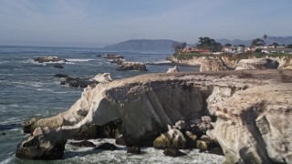 AXSF02_032 - 5K aerial stock footage of approaching coastal cliffs, revealing rock formations, Shell Beach, California