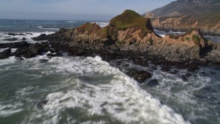 AXSF02_051 - 5K aerial stock footage fly over waves, rock formations, tilt to reveal coastal cliffs, Avila Beach, California