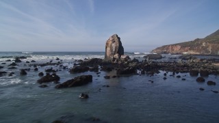 AXSF02_054 - 5K aerial stock footage of flying low past rock formations off the coast, Avila Beach, California