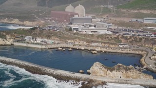 AXSF02_060 - 5K aerial stock footage tilt from ocean, reveal Diablo Canyon Power Plant nuclear facility, Avila Beach, California