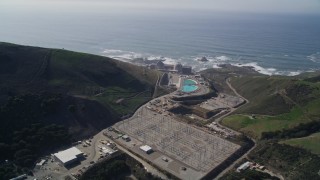 AXSF02_065 - 5K aerial stock footage of Diablo Canyon Power Plant nuclear facility, seen from hills, Avila Beach, California