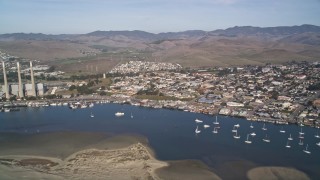 AXSF03_007 - 5K aerial stock footage of a beach, coastal homes by the harbor, pan to reveal Dynegy Power Plant, Morro Bay, California