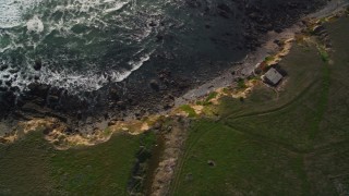 AXSF03_025 - 5K aerial stock footage of a bird's eye view of the rocky coastline and coastal cliffs, Cambria, California