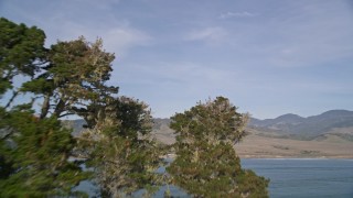 AXSF03_045 - 5K aerial stock footage fly low over the ocean and a peninsula to reveal San Simeon Bay, San Simeon, California
