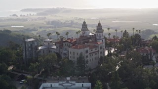 AXSF03_049 - 5K aerial stock footage of flying by the east and north side of historic Hearst Castle, San Simeon, California
