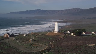 AXSF03_055 - 5K aerial stock footage approach and flyby Point Piedras Blancas lighthouse, San Simeon, California