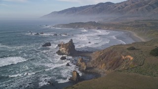 AXSF03_058 - 5K aerial stock footage approach the coastline from over Highway 1, San Simeon, California