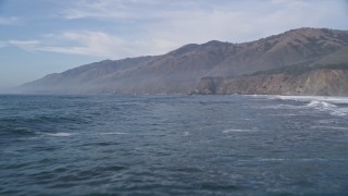 AXSF03_060 - 5K aerial stock footage of approaching coastal cliffs, San Simeon, California
