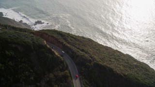 AXSF03_069 - 5K aerial stock footage track white convertible on Highway 1, above coastal cliffs, Big Sur, California