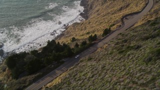 AXSF03_070 - 5K aerial stock footage bird's eye view of Highway 1 winding along hills above the coast, Big Sur, California