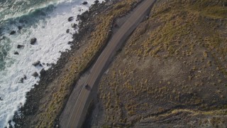 AXSF03_074 - 5K aerial stock footage of tracking a car traveling on Highway 1 along the coast, Big Sur, California