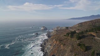 AXSF03_076 - 5K aerial stock footage of approaching a large rock formation off the coast, Big Sur, California