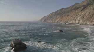AXSF03_098 - 5K aerial stock footage fly over rock formations by coastal cliffs, Big Sur, California