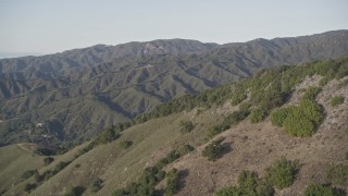 AXSF03_111 - 5K aerial stock footage of flying over green mountains in Los Padres National Forest, California