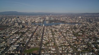 AXSF05_001 - 5K aerial stock footage of flying over urban neighborhoods toward Lake Merritt, Downtown Oakland, California