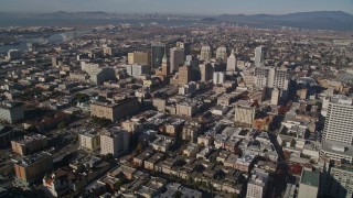 AXSF05_003 - 5K aerial stock footage approach and pan across city buildings in Downtown Oakland, California