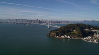 AXSF05_007 - 5K aerial stock footage flying by Yerba Buena Island, with a view of the Bay Bridge, San Francisco, California