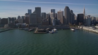 AXSF05_009 - 5K aerial stock footage tilt from bay to reveal and fly over the Ferry Building into Downtown San Francisco, California