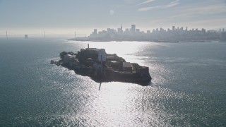 AXSF05_021 - 5K aerial stock footage of iconic Alcatraz, reveal city skyline and Bay Bridge, San Francisco, California