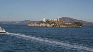 AXSF05_023 - 5K aerial stock footage orbit a ferry sailing the bay and reveal Alcatraz, San Francisco, California