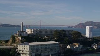 AXSF05_025 - 5K aerial stock footage flyby Alcatraz and reveal Golden Gate Bridge in the far distance, San Francisco, California