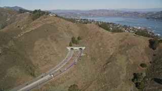 AXSF05_044 - 5K aerial stock footage of approaching Robin Williams Tunnel (Waldo Tunnel), Marin Hills, Sausalito, California